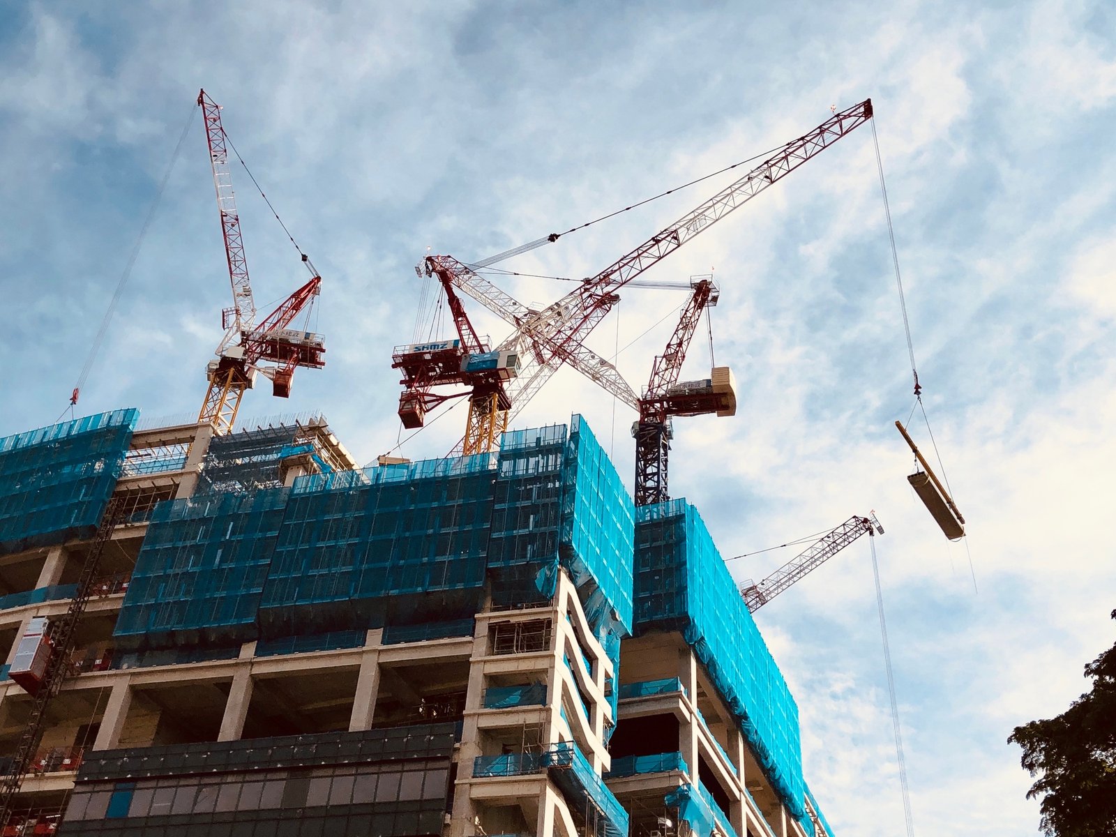 Cranes and building construction heavy equipments on site.